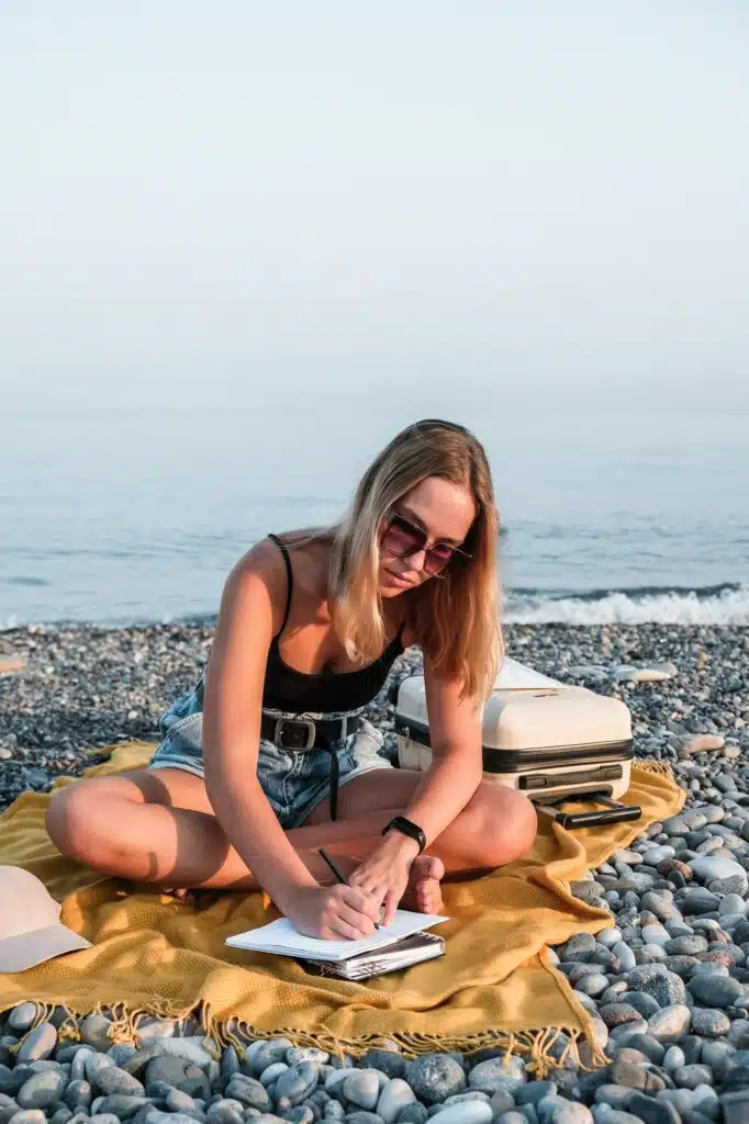 Goals girl on the seashore writes goals, plans year. Motivation, inspiration, dreams and travel pla